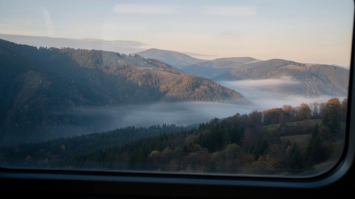 Sunrise over a wooded ridge seen from the overnight train to the Carpathians